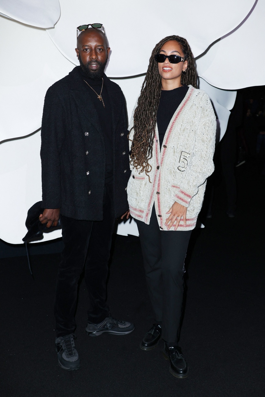 Ladj Ly and his wife at the Chanel show during Paris Fashion Week Ladj Ly and his wife at the Chanel show during Paris Fashion Week
